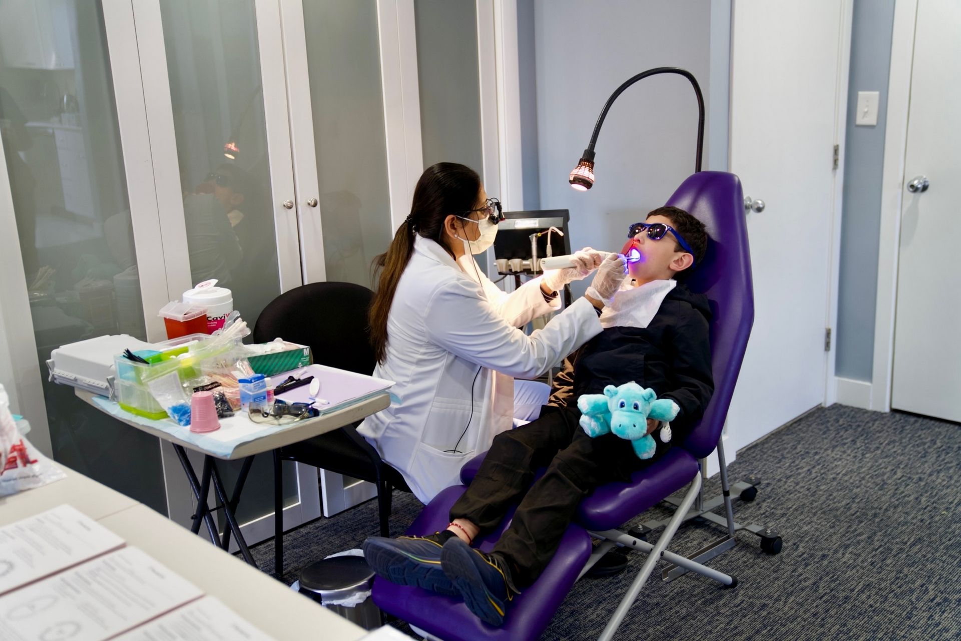 Dental hygienist treating a child in a school setting